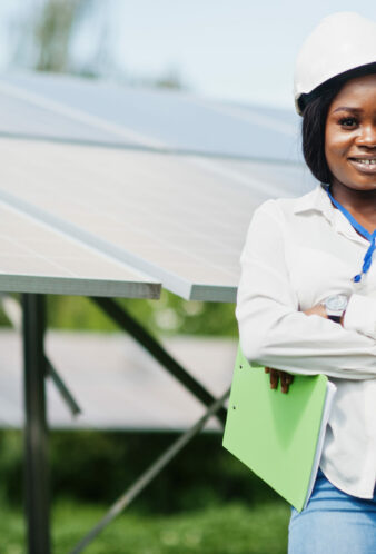African american technician check the maintenance of the solar panels. Black woman engineer at solar station.